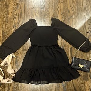 Cute little black dress, with sheer sleeves.